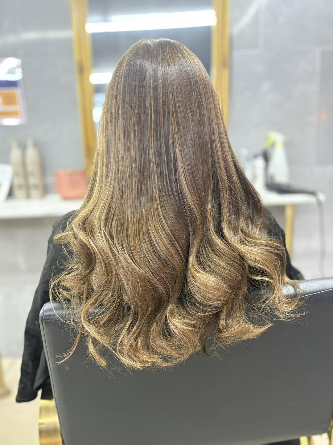 Glossy brunette hair styled in soft curls